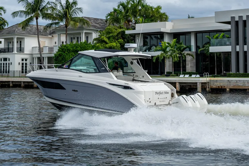  Yacht Photos Pics 2023 Sea Ray Sundancer 320 Outboard cruising near luxury waterfront homes.