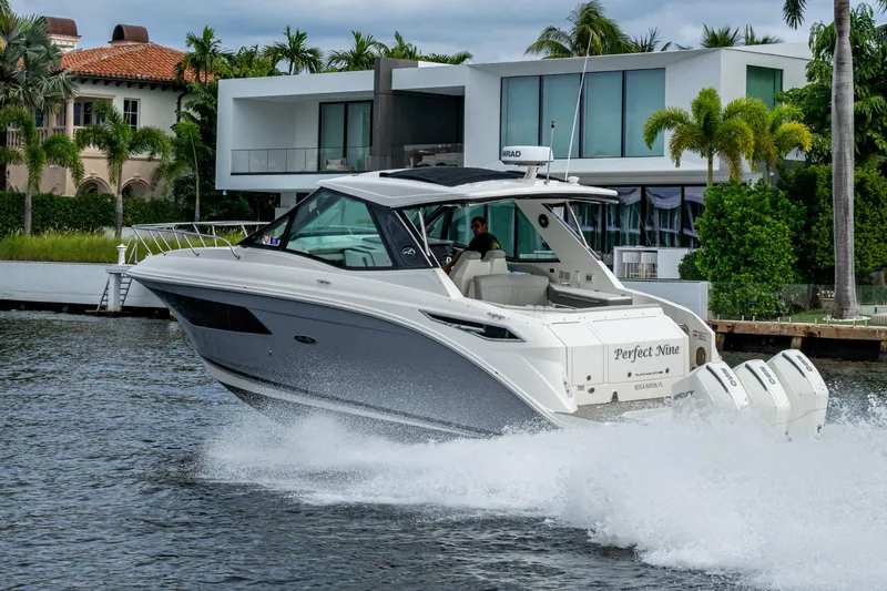  Yacht Photos Pics 2023 Sea Ray Sundancer 320 Outboard cruising near modern waterfront homes.