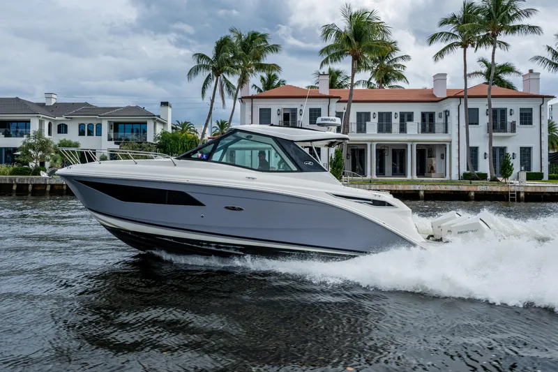  Yacht Photos Pics 2023 Sea Ray Sundancer 320 Outboard cruising near luxury waterfront homes.