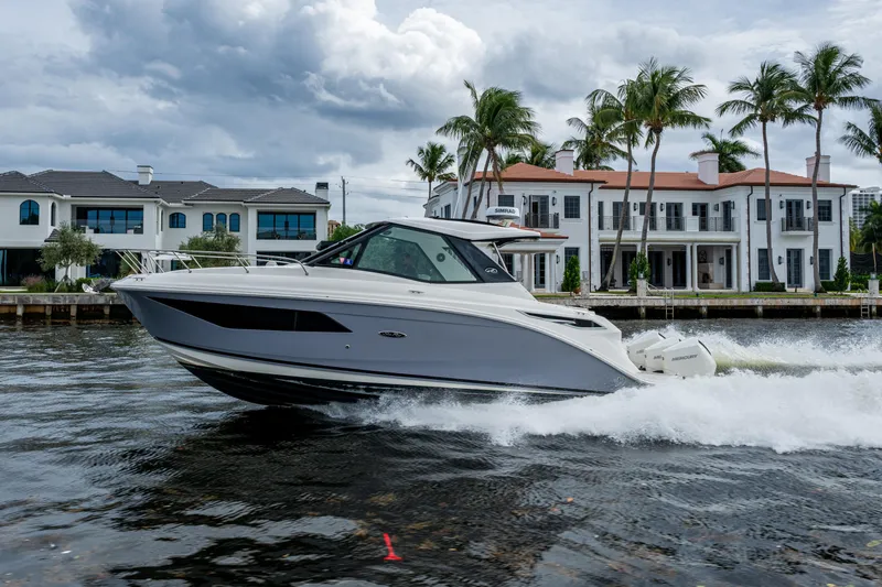  Yacht Photos Pics 2023 Sea Ray Sundancer 320 Outboard cruising near luxury waterfront homes.
