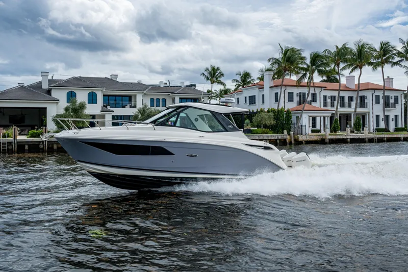  Yacht Photos Pics 2023 Sea Ray Sundancer 320 Outboard cruising near luxury waterfront homes.