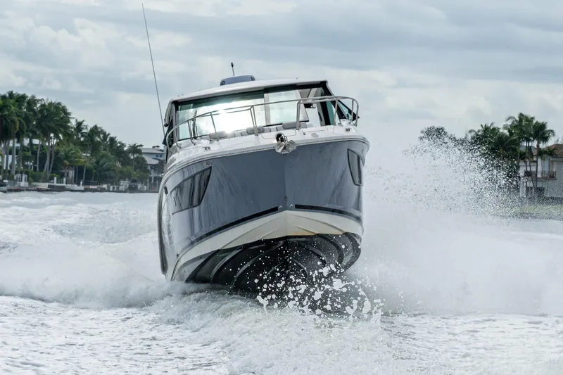  Yacht Photos Pics 2023 Sea Ray Sundancer 320 Outboard cruising on water, creating dynamic waves.