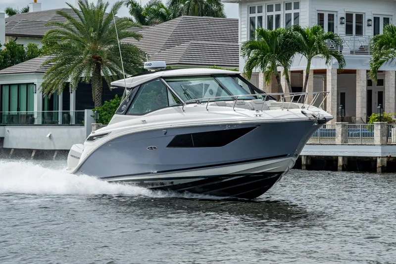 Yacht Photos Pics 2023 Sea Ray Sundancer 320 Outboard cruising near waterfront homes.