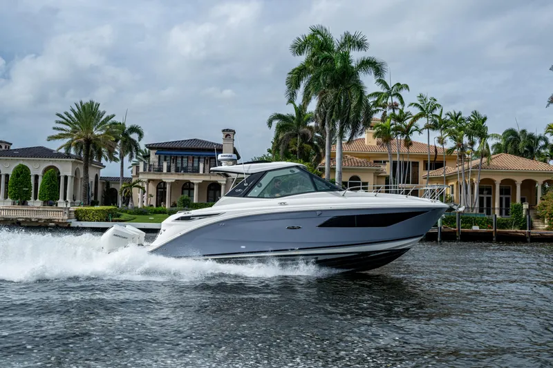  Yacht Photos Pics 2023 Sea Ray Sundancer 320 Outboard cruising near luxury waterfront homes.