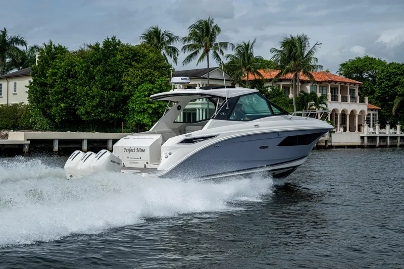  Yacht Photos Pics 2023 Sea Ray Sundancer 320 Outboard cruising on a scenic waterway with luxury homes.