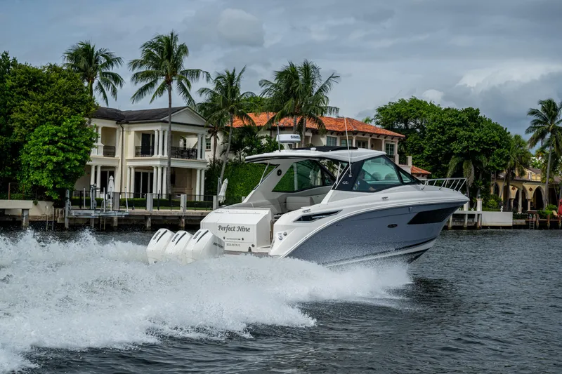  Yacht Photos Pics 2023 Sea Ray Sundancer 320 Outboard cruising near luxury waterfront homes.