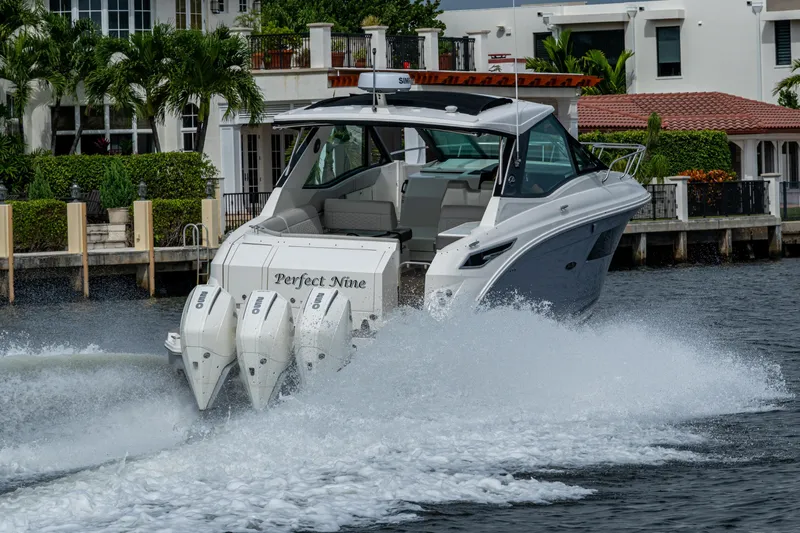  Yacht Photos Pics 2023 Sea Ray Sundancer 320 Outboard cruising on water near luxury waterfront homes.