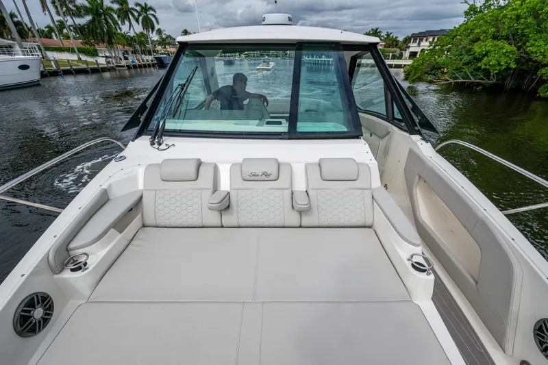  Yacht Photos Pics 2023 Sea Ray Sundancer 320 Outboard boat with spacious seating on a calm waterway.