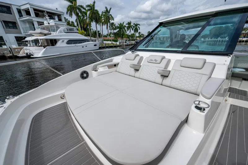  Yacht Photos Pics 2023 Sea Ray Sundancer 320 Outboard with luxurious seating, docked near waterfront homes.