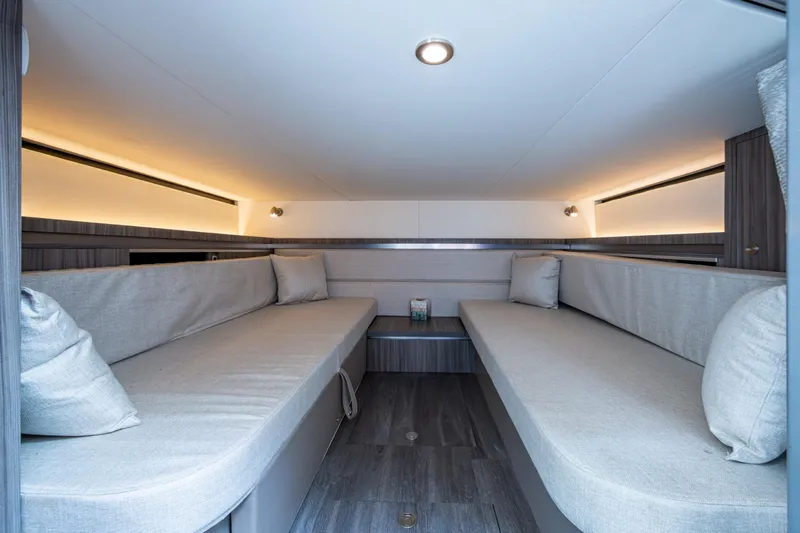  Yacht Photos Pics 2023 Sea Ray Sundancer 320 Outboard cabin interior with modern seating and ambient lighting.