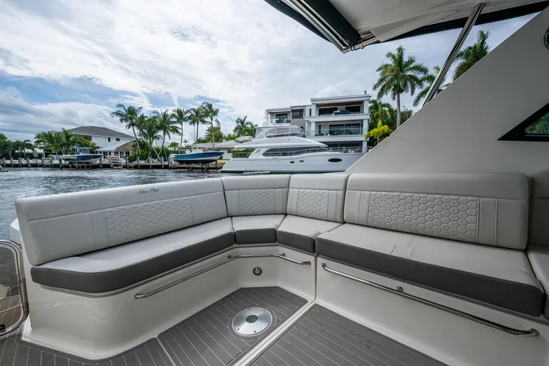 Yacht Photos Pics Luxurious seating on 2023 Sea Ray Sundancer 320 Outboard, docked near waterfront homes.