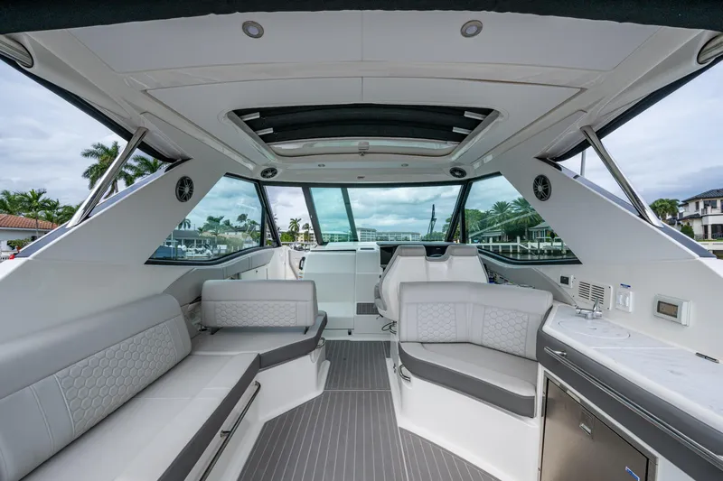  Yacht Photos Pics Luxurious interior of 2023 Sea Ray Sundancer 320 Outboard, featuring sleek seating and modern amenities.