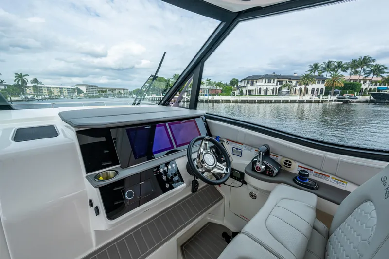  Yacht Photos Pics 2023 Sea Ray Sundancer 320 Outboard helm with modern controls and waterfront view.