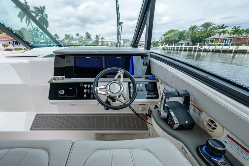  Yacht Photos Pics 2023 Sea Ray Sundancer 320 Outboard helm with modern controls and waterfront view.