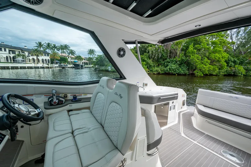  Yacht Photos Pics 2023 Sea Ray Sundancer 320 Outboard interior with luxurious seating and scenic waterway view.