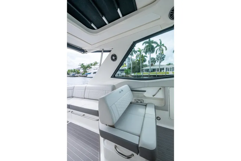  Yacht Photos Pics 2023 Sea Ray Sundancer 320 Outboard interior with sleek seating and waterfront view.