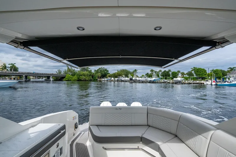  Yacht Photos Pics 2023 Sea Ray Sundancer 320 Outboard, rear view, cruising on a scenic waterway.