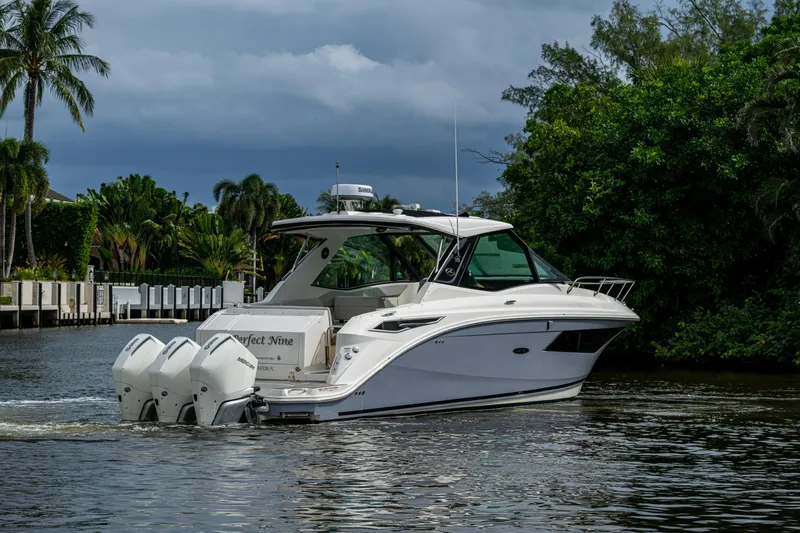 Yacht Photos Pics 2023 Sea Ray Sundancer 320 Outboard cruising on a scenic waterway.