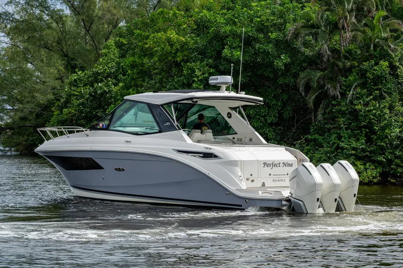  Yacht Photos Pics 2023 Sea Ray Sundancer 320 Outboard cruising on a scenic waterway.