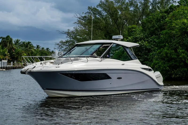  Yacht Photos Pics 2023 Sea Ray Sundancer 320 Outboard cruising on a scenic waterway.
