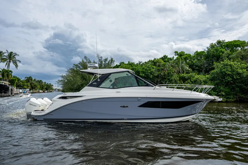 Yacht Photos Pics 2023 Sea Ray Sundancer 320 Outboard cruising on a scenic waterway.