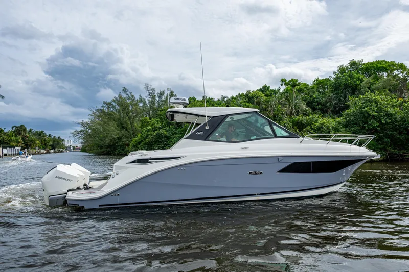  Yacht Photos Pics 2023 Sea Ray Sundancer 320 Outboard cruising on a scenic waterway.