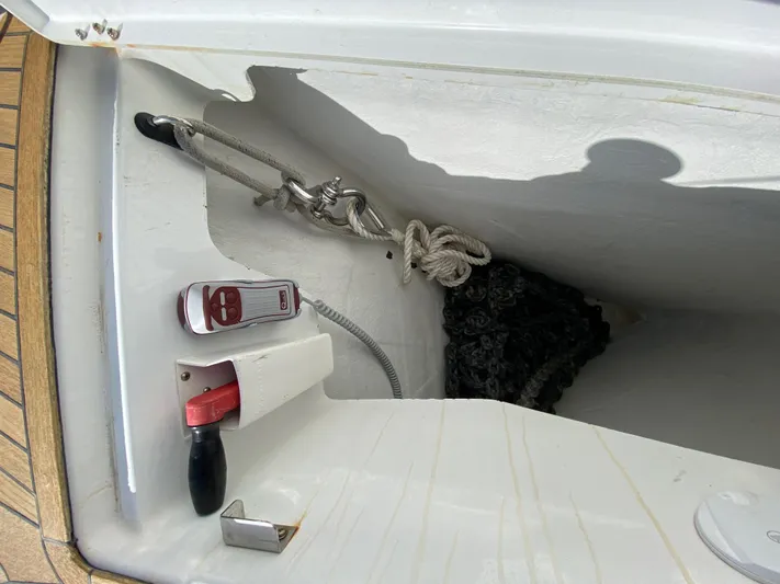  Yacht Photos Pics Anchor locker of 2013 Jeanneau 57 sailboat with rope and winch handle.