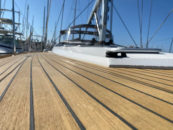  Yacht Photos Pics Close-up of 2013 Jeanneau 57 yacht deck with sleek wooden finish.