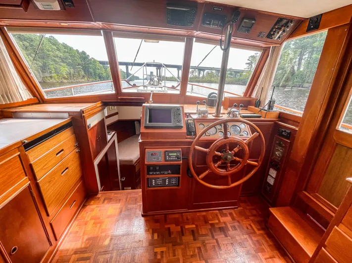 Tallulah Yacht Photos Pics 1989 Grand Banks 42 Classic yacht interior with wooden helm and navigation equipment.