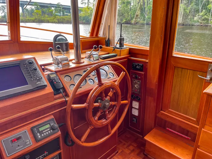 Tallulah Yacht Photos Pics 1989 Grand Banks 42 Classic helm with wooden wheel and navigation instruments.