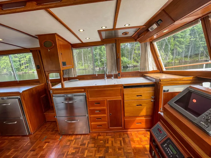 Tallulah Yacht Photos Pics Interior of 1989 Grand Banks 42 Classic yacht with wood cabinetry and modern appliances.