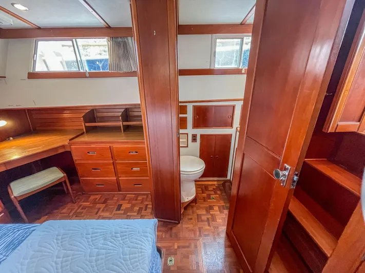 Tallulah Yacht Photos Pics 1989 Grand Banks 42 Classic cabin interior with wood finish, desk, and bathroom.