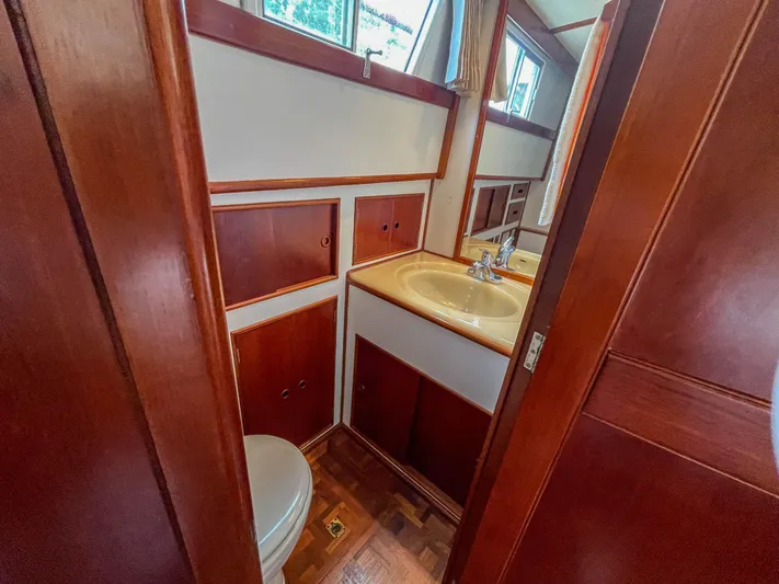 Tallulah Yacht Photos Pics 1989 Grand Banks 42 Classic yacht bathroom with wooden cabinetry and sink.