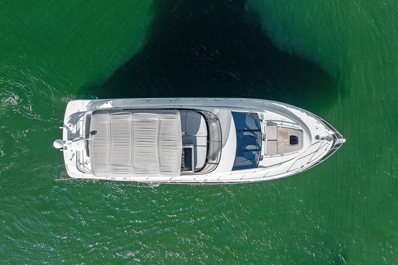 Guilty Pleasure Yacht Photos Pics Aerial view of 2014 Sea Ray 510 Fly yacht on green water.