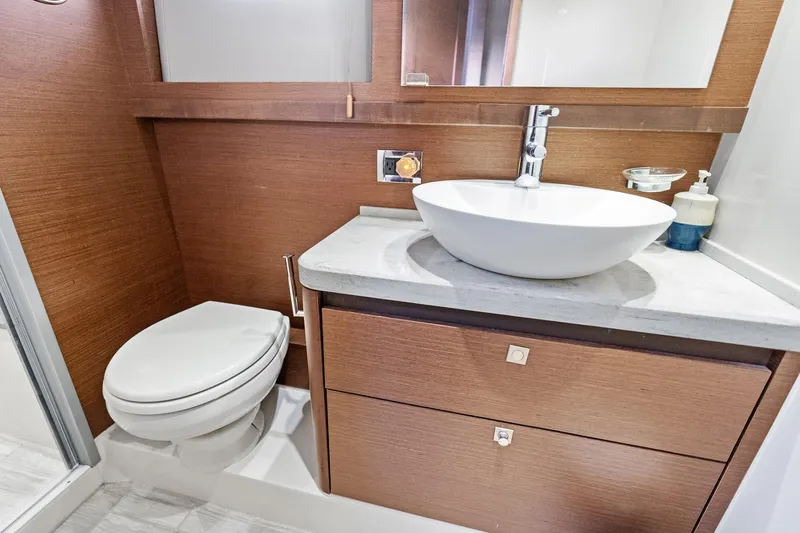 Guilty Pleasure Yacht Photos Pics Luxurious bathroom in 2014 Sea Ray 510 Fly yacht with modern sink and toilet.
