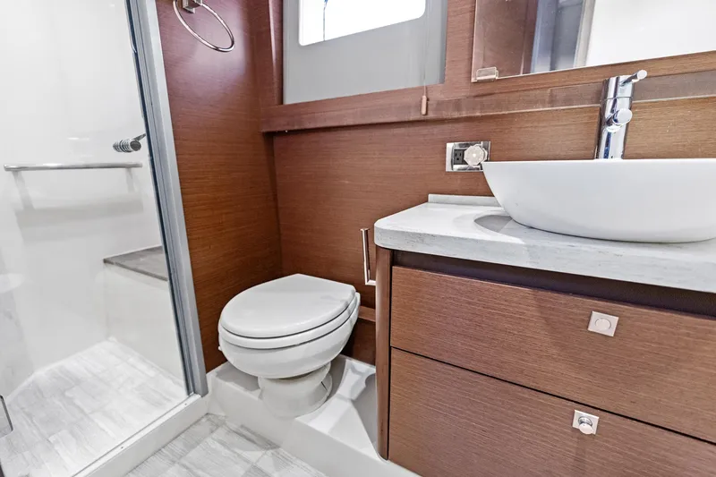 Guilty Pleasure Yacht Photos Pics Luxurious bathroom in 2014 Sea Ray 510 Fly yacht with modern fixtures and wood accents.
