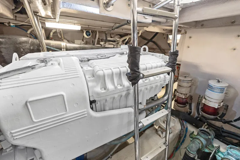 Guilty Pleasure Yacht Photos Pics Engine room of 2014 Sea Ray 510 Fly yacht with visible machinery and ladder.