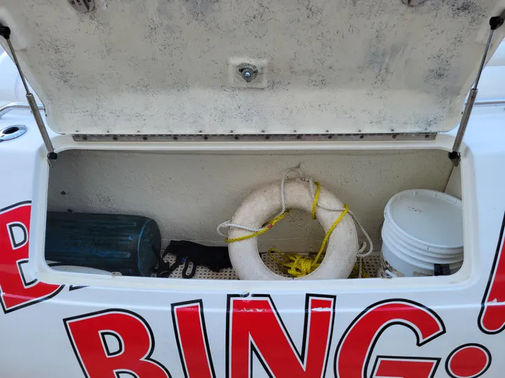 Bada Bing II Yacht Photos Pics Storage compartment on a 2000 Sea Ray 540 Sundancer with life ring and bucket.