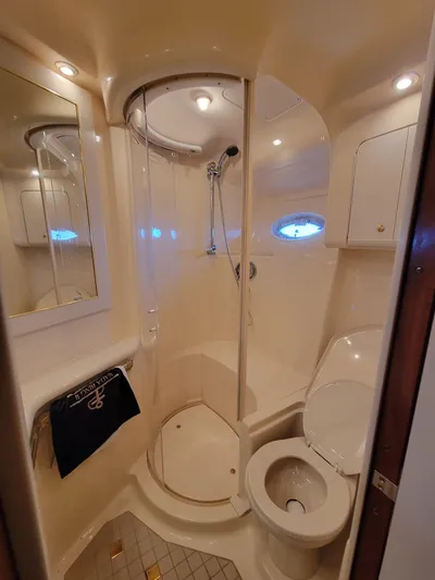 Bada Bing II Yacht Photos Pics 2000 Sea Ray 540 Sundancer bathroom with shower, toilet, and mirror.