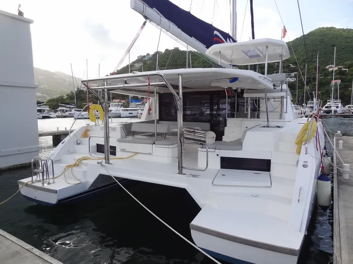 Good Times Yacht Photos Pics 2020 Leopard 45 catamaran docked at marina with scenic hillside backdrop.