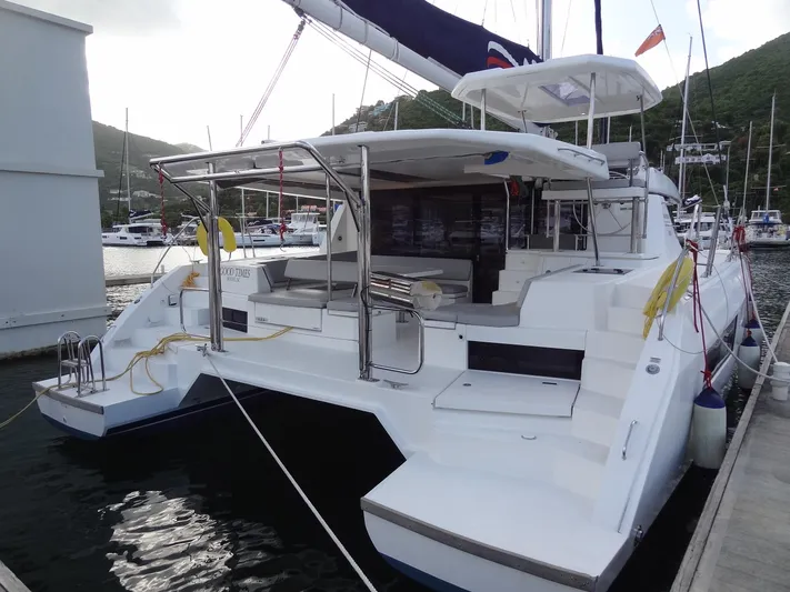 Good Times Yacht Photos Pics 2020 Leopard 45 catamaran docked in a marina, showcasing spacious deck and modern design.