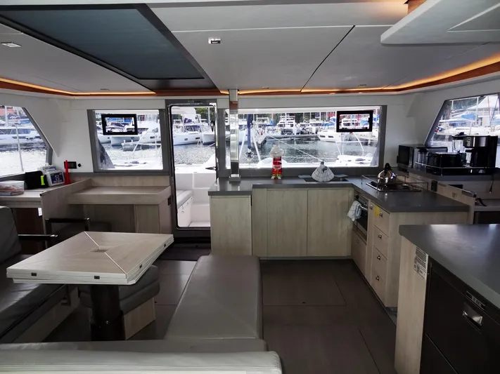 Good Times Yacht Photos Pics Modern interior of a 2020 Leopard 45 catamaran with kitchen and seating area.