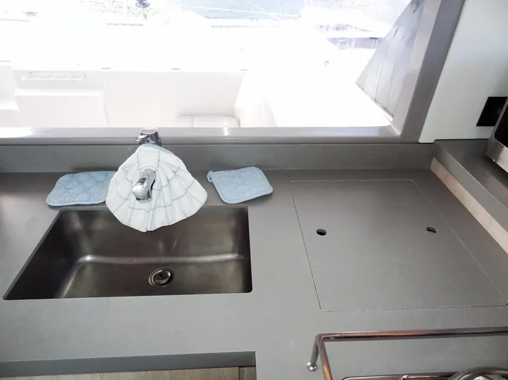 Good Times Yacht Photos Pics Modern kitchen sink area on a 2020 Leopard 45 yacht, featuring sleek countertops.
