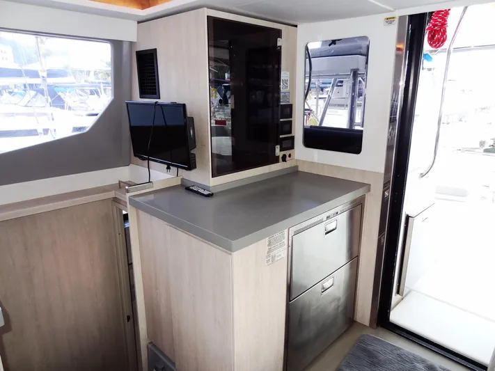 Good Times Yacht Photos Pics Interior of 2020 Leopard 45 yacht with modern kitchenette and small TV.