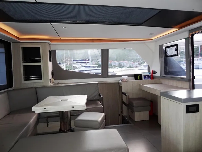 Good Times Yacht Photos Pics Modern interior of a 2020 Leopard 45 yacht with sleek seating and large windows.