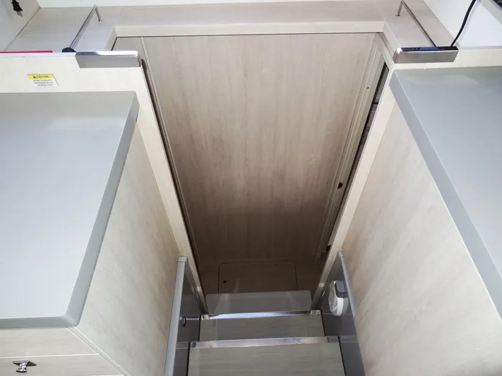 Good Times Yacht Photos Pics Stairway inside 2020 Leopard 45 yacht, featuring sleek wooden design and modern finishes.