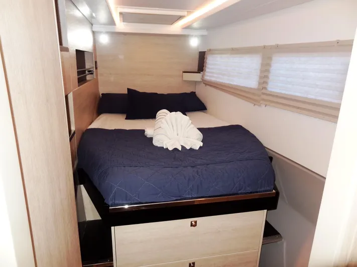 Good Times Yacht Photos Pics Luxurious cabin interior of 2020 Leopard 45 yacht with cozy bed and elegant decor.