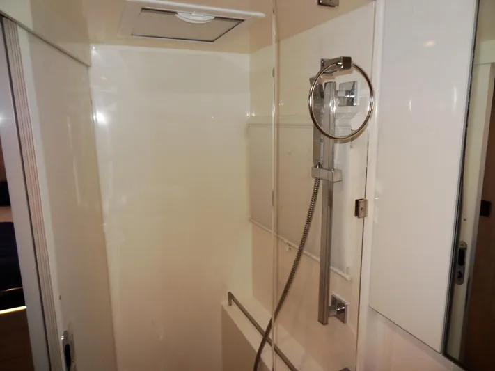 Good Times Yacht Photos Pics Modern shower area in a 2020 Leopard 45 yacht, featuring sleek fixtures and white walls.