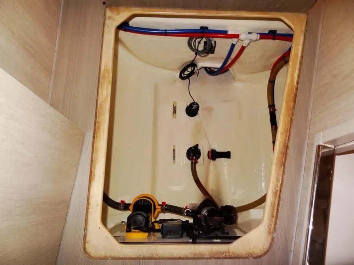Good Times Yacht Photos Pics Bilge compartment of a 2020 Leopard 45 yacht with visible plumbing and wiring.