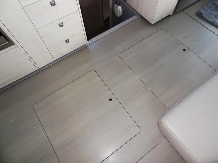 Good Times Yacht Photos Pics Interior of 2020 Leopard 45 yacht showing sleek wooden flooring and storage compartments.